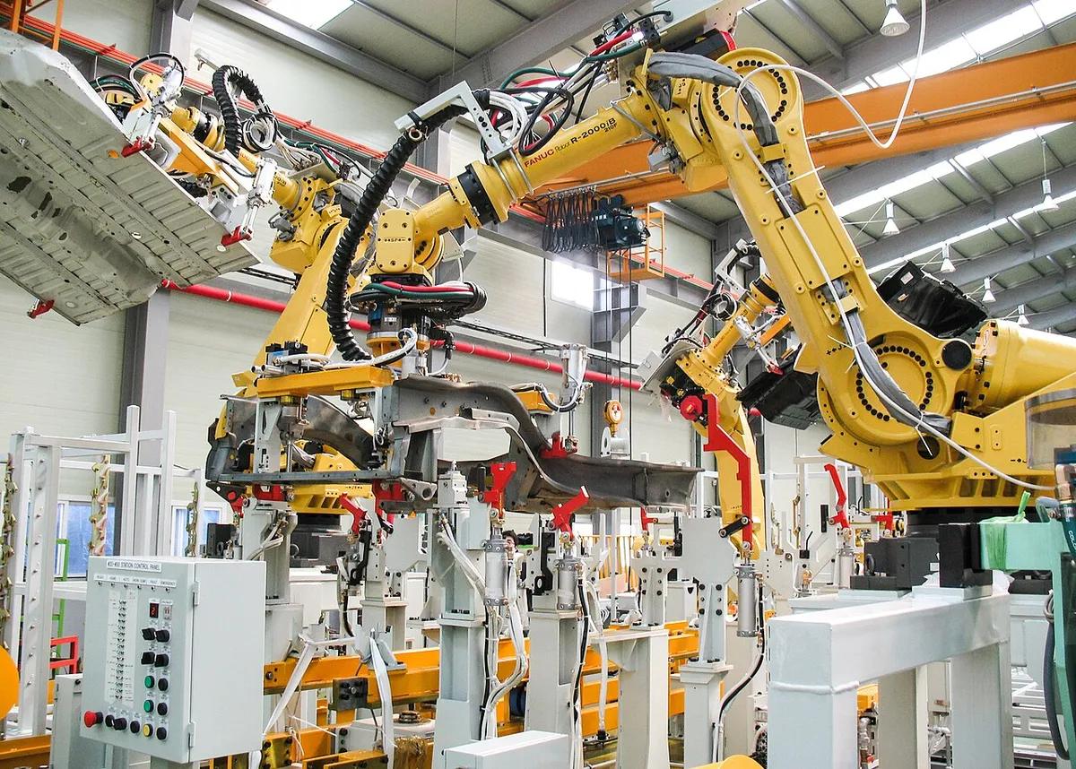 Industrial robots handling parts on a production line